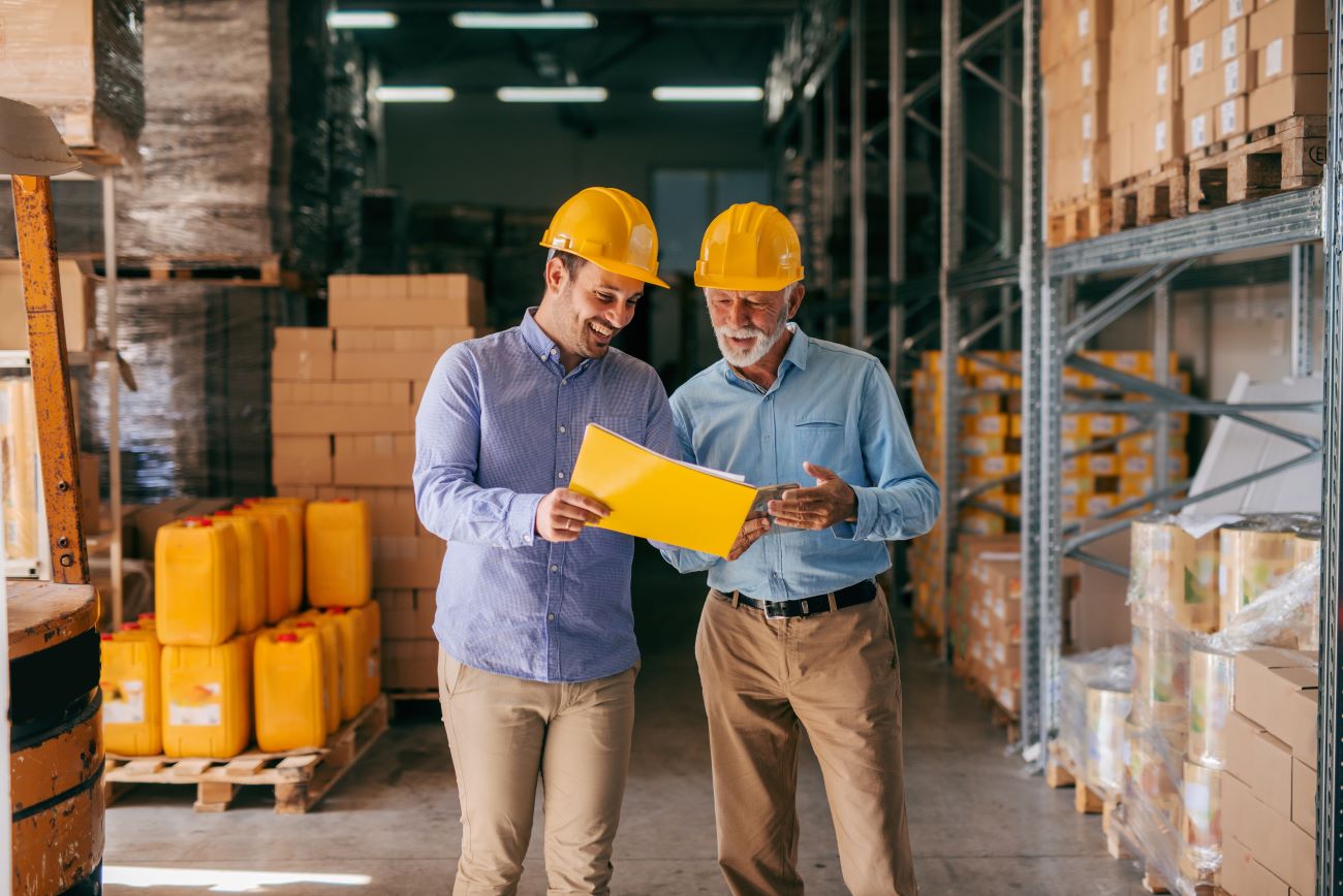 Coworkers in a warehouse discussing something