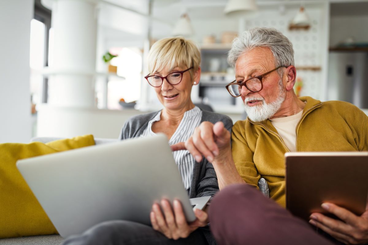 Couple reviewing documents sitting on a couch